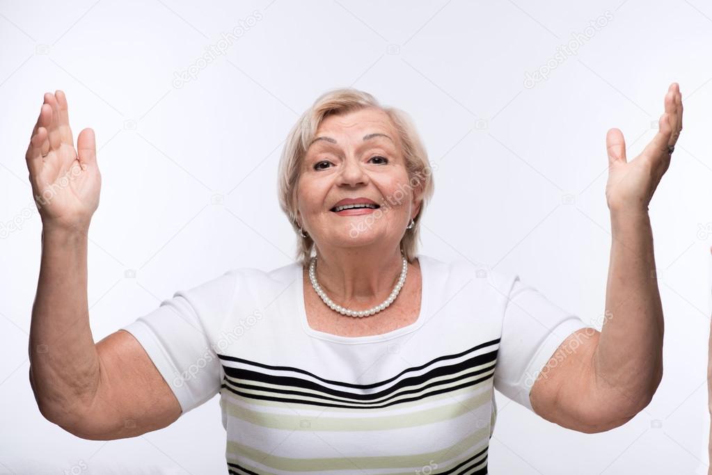 Elderly lady raising hands