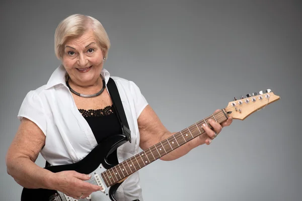 Elderly woman holding the guitar