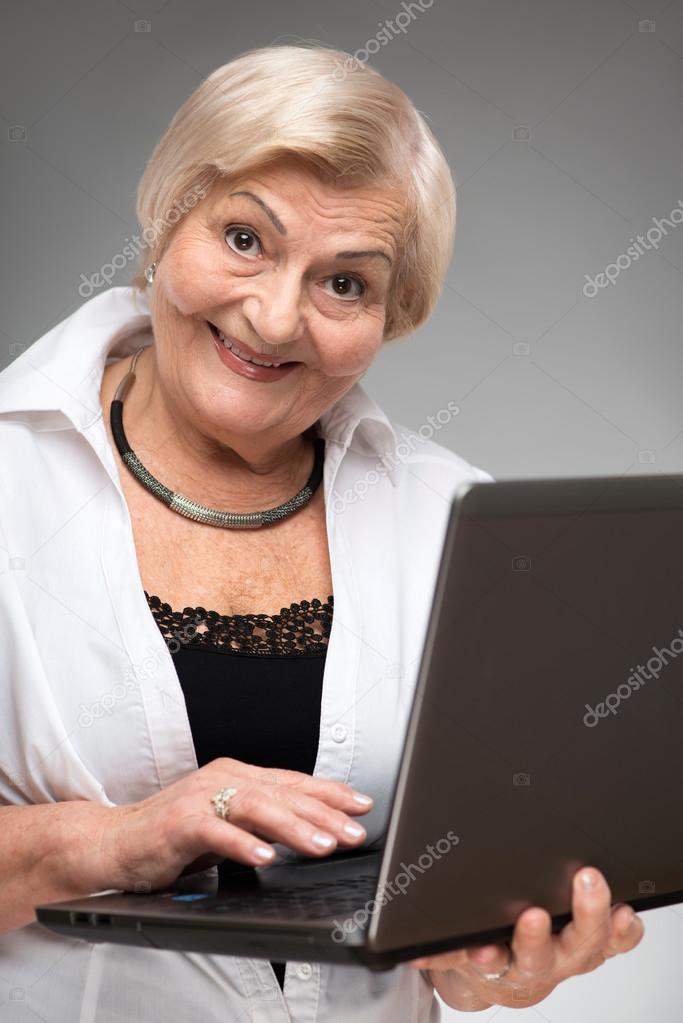 Elderly woman holding the laptop