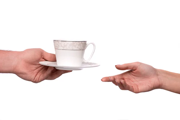 Hand gebende Tasse und Untertasse — Stockfoto