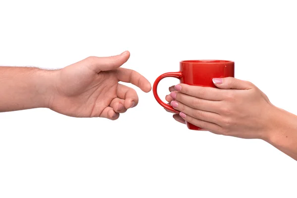 Hand passing a mug of coffee — Stock Photo, Image