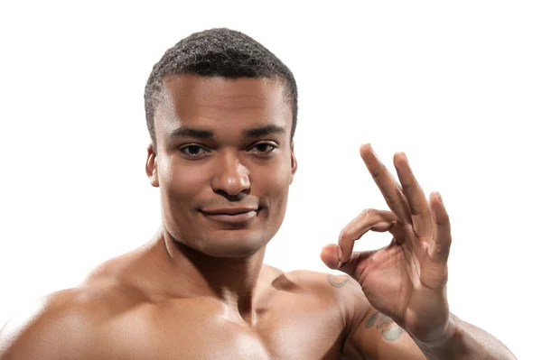 Retrato de un joven deportista mostrando signos — Foto de Stock