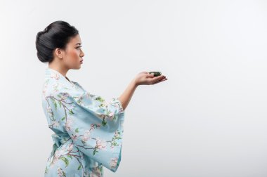 Tea ceremony conducted by Asian woman clipart