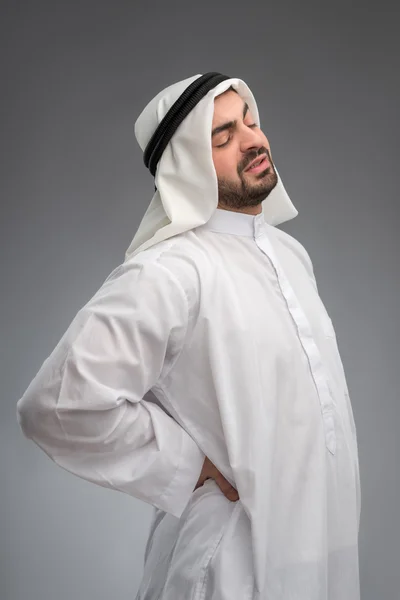 Middle aged Arab touching his aching waist — Stock Photo, Image