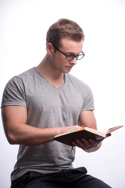 Young man holding a book — Stock Photo, Image