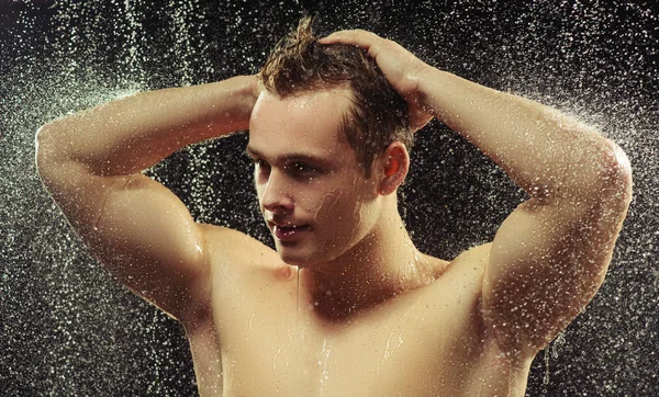 Handsome young man taking a shower — Stock Photo, Image