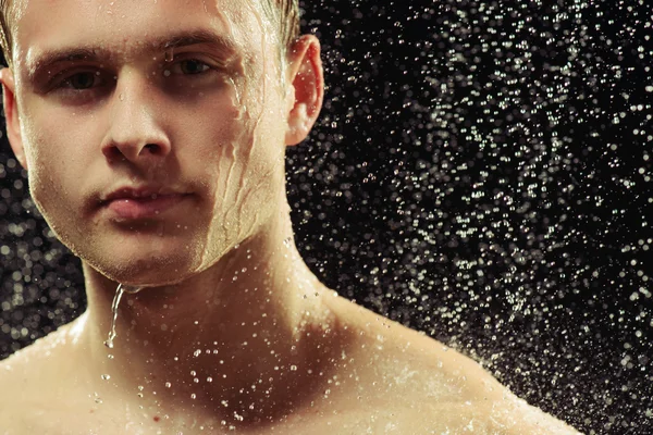 Handsome young man taking a shower — Stock Photo, Image