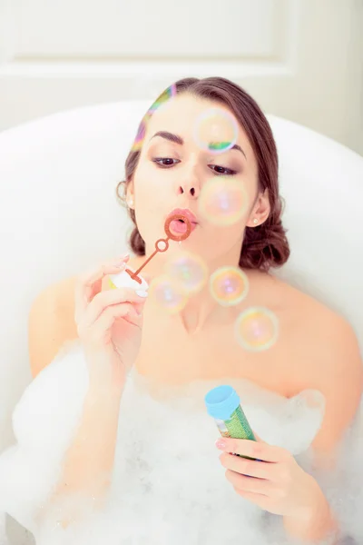 Beautiful young woman taking a bath — Stock Photo, Image