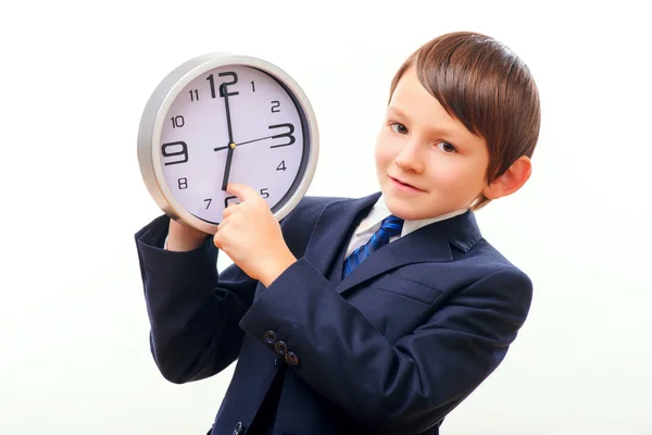 Business child in suit and tie posing with clock — Stock Photo, Image