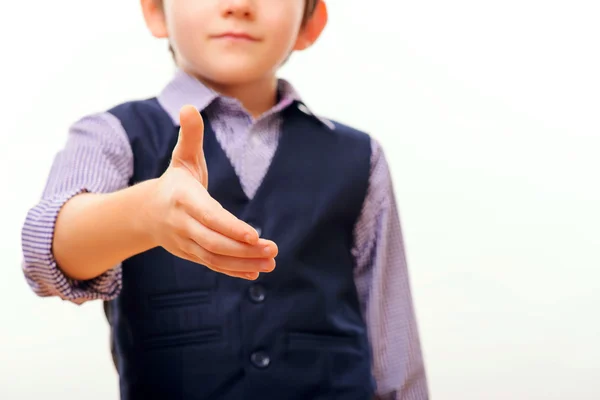 Cute child in suit stretching out hand — Stock Photo, Image