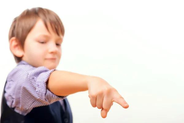 Cute schoolchild in suit pointing down — Stock Photo, Image