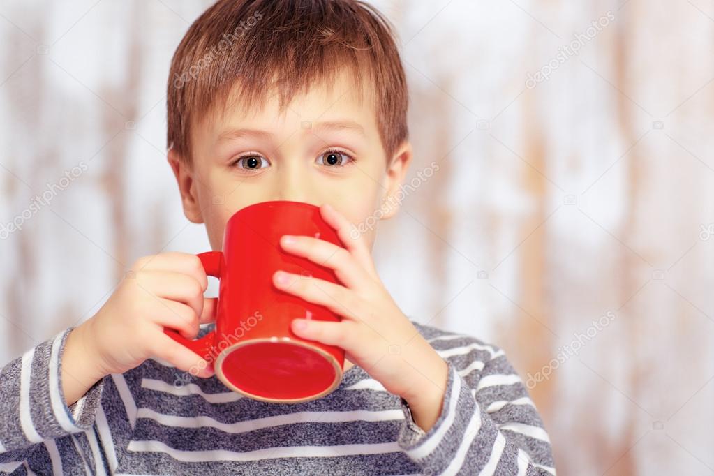 Portrait of little boy with a cup