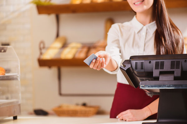 Beautiful young saleswoman in a bakery