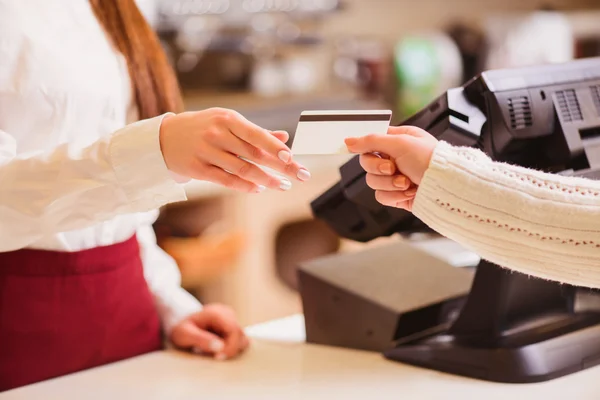 Customer paying to shop assistant Stock Image