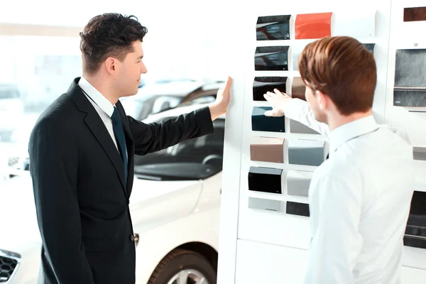 Handsome young man in dealership — Stock Photo, Image