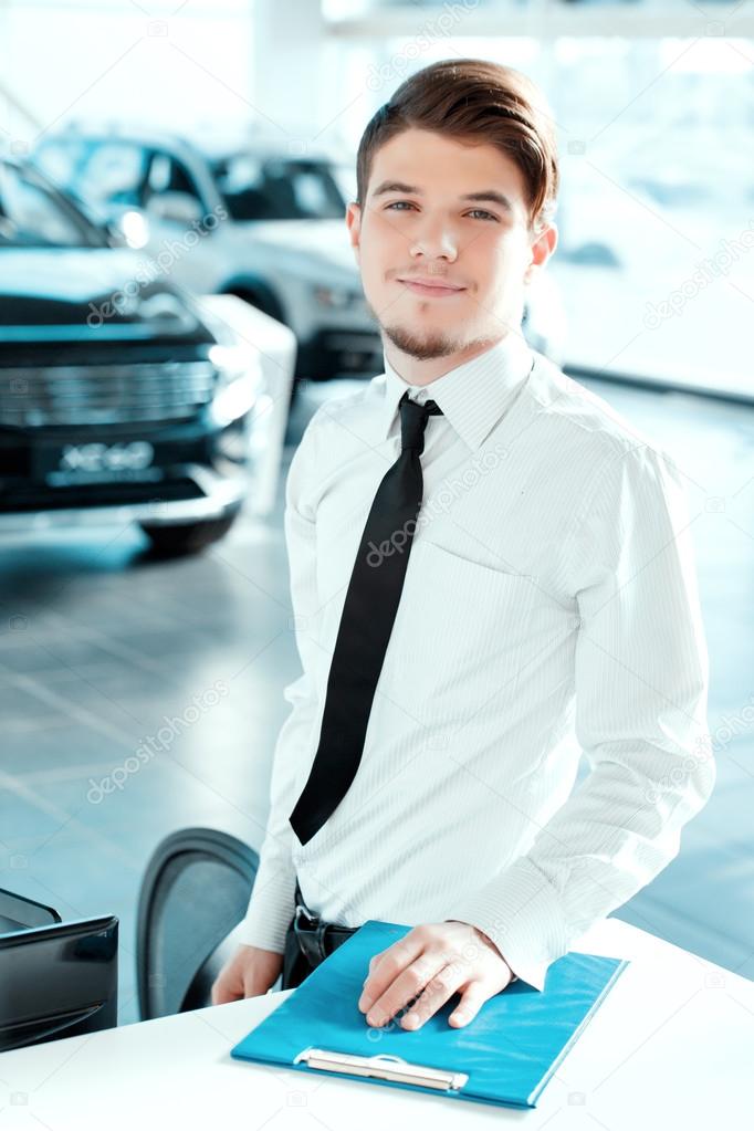 Handsome young man in dealership