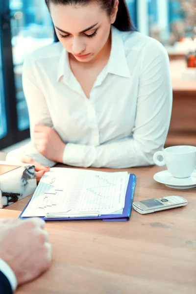 Woman in formalwear looking at documents — Stock Photo, Image