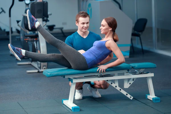 Hermosa chica en el club deportivo con instructor — Foto de Stock