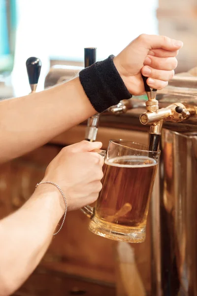 Barman vierte cerveza fresca en el vaso —  Fotos de Stock