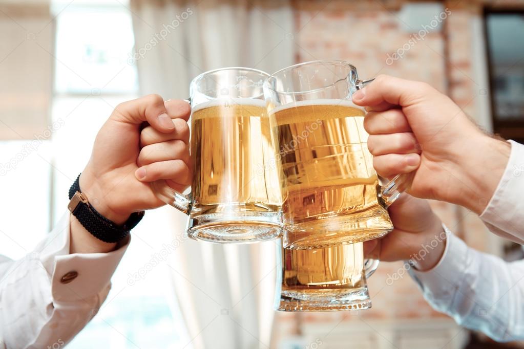 Three glasses of beer in focus