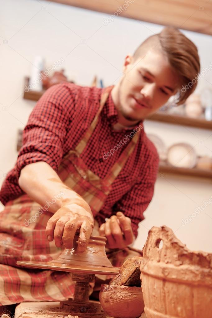 Man making a clay jar