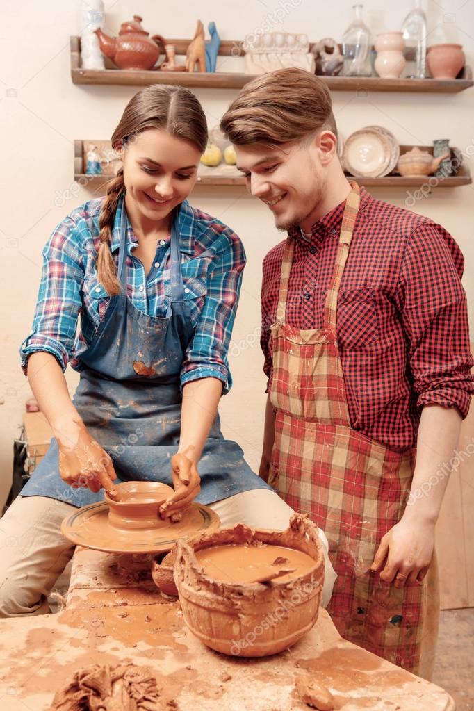Couple works on the pottery wheel — Stock Photo © Dmyrto_Z 68776181