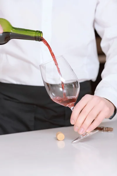 Sommelier pours wine into glass — Stock Photo, Image
