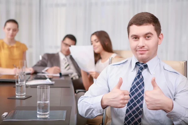 Businessman shows thumbs up