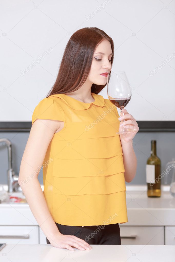 Woman smelling glass of wine