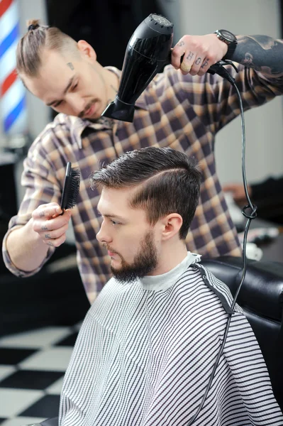 Hairdresser dries hair of a male client — Stock Photo, Image