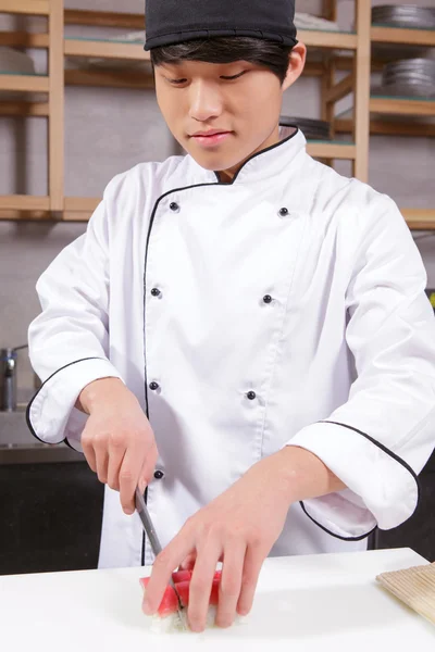 Cook cuts sushi rolls — Stock Photo, Image