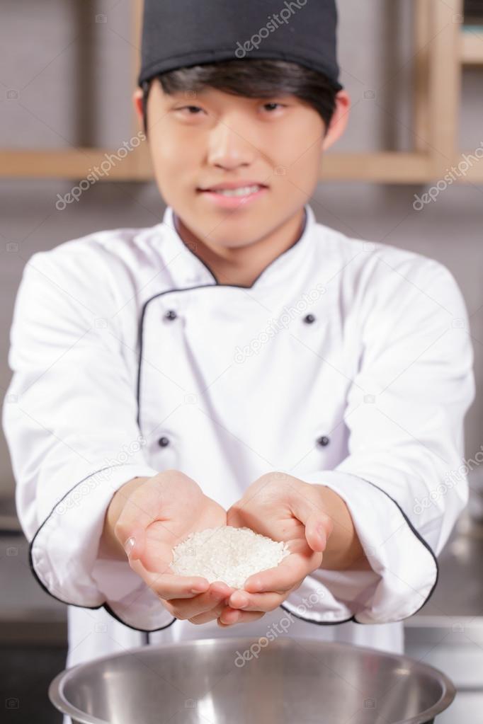 Sushi chef cooks rice