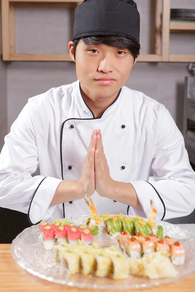 Asian chef cook welcomes guests — Stock Photo, Image