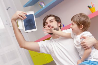 Father and son use tablet clipart