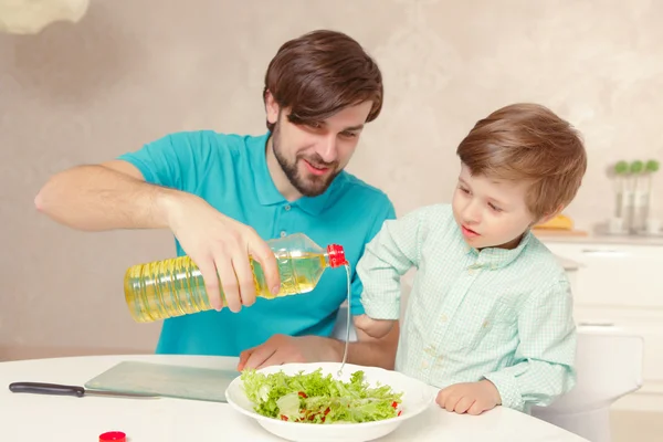 Father and son make salad dressing — Stock Photo, Image