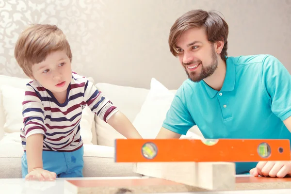 Father and son play with a building kit — Stock Photo, Image