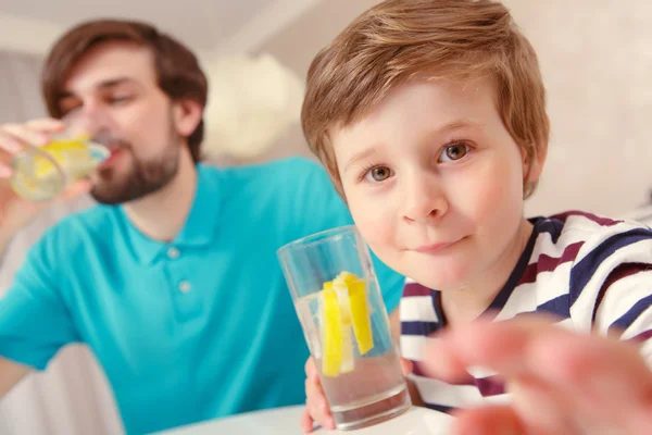 Pai e filho bebem limonada — Fotografia de Stock