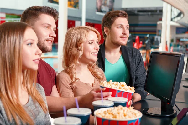 Group of people buying popcorn and coke