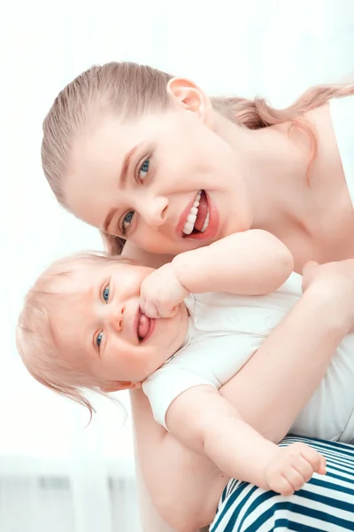 Young mother holding her baby — Stock Photo, Image