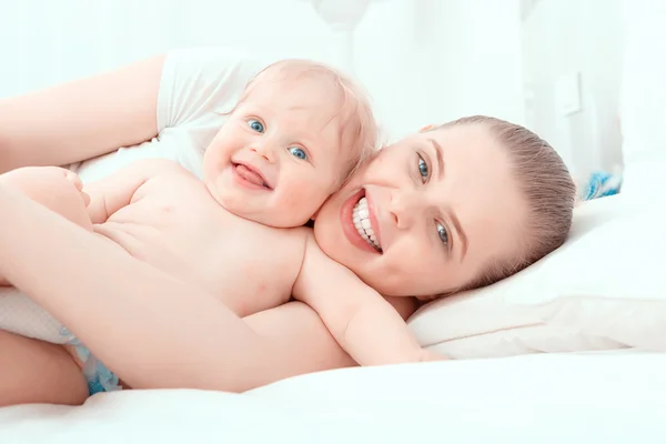 Madre y su pequeño bebé en la cama — Foto de Stock