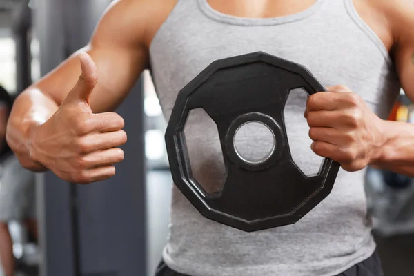 Weightlifter holding disk with thumbs up — Stock Photo, Image