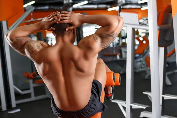 Back view of man doing abdominal crunches — Stock Photo, Image