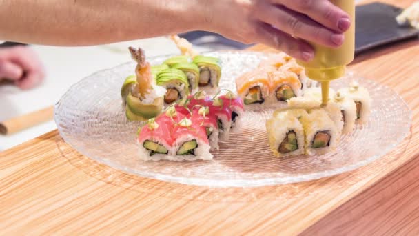 Asian chef in white uniform preparing with avocado and seasoning it with sauce — Stock Video