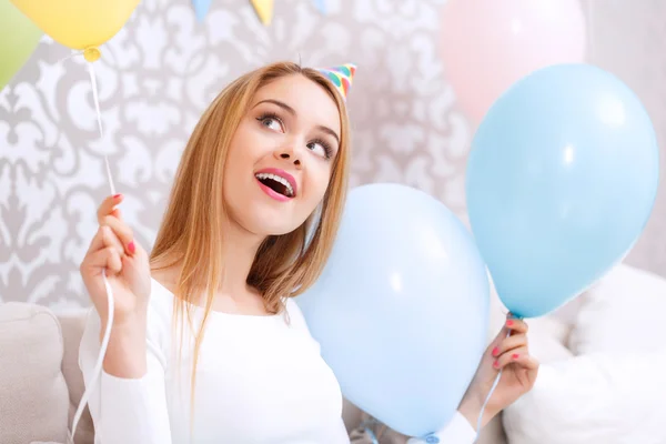 Happy girl on a couch celebrating — Stock Photo, Image