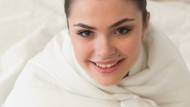 Young smiling woman sitting on bed — Stock Video