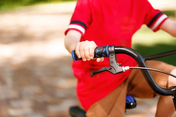 Close up of little kid riding bike — Stock Photo, Image