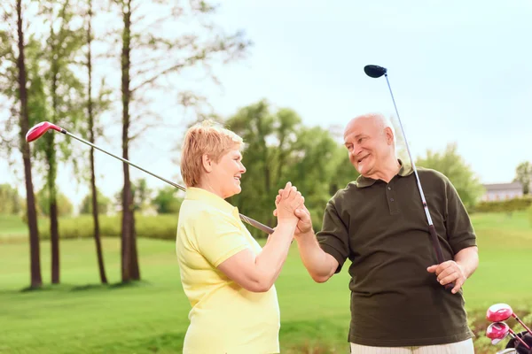 Senior man and woman holding hands together — Stock Photo, Image