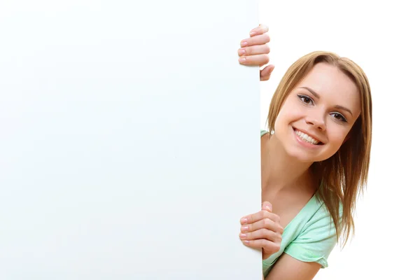 Smiling woman emerging from behind corner — Stock Photo, Image