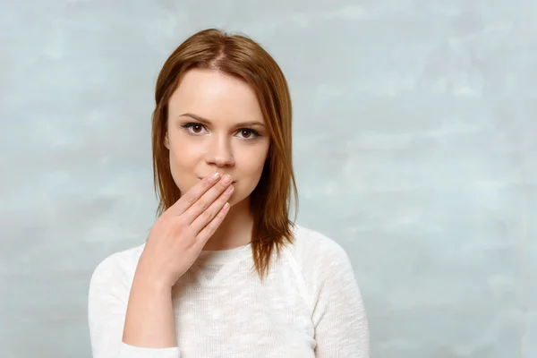 Young lady covering her mouth with hand — Stock Photo, Image