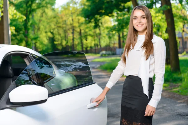 Lachende vrouw opening deur van auto — Stockfoto